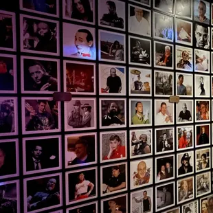 a wall full of photos of people