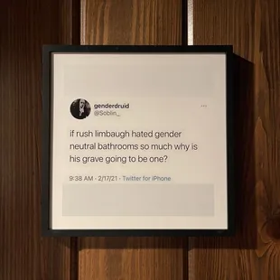 a tweet on a wooden wall