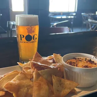 a plate of nachos and a glass of beer