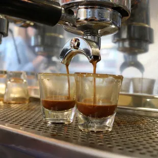 espressor being poured into shot glasses