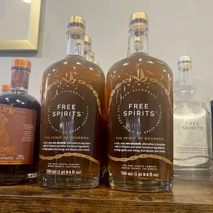 three bottles of spirits on a shelf