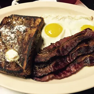 French toast, sunny side eggs, and beef bacon