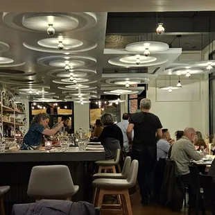 people sitting at a bar in a restaurant