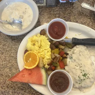 Chicken fried steak and biscuit in gravy