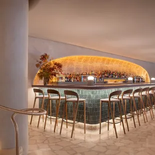 a bar with stools at the bar