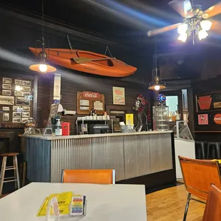a bar with a surfboard on the wall