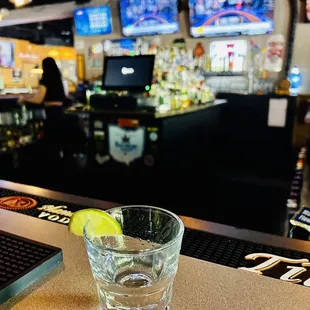 a shot of a glass of water on a bar counter