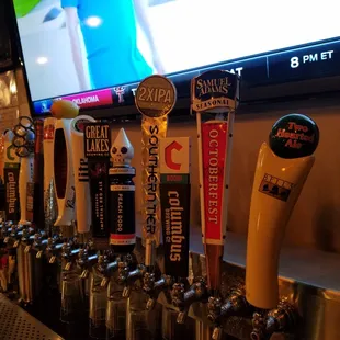 a row of beer taps on a bar