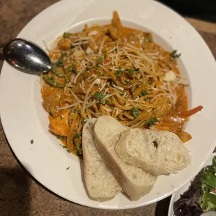 a plate of pasta and bread