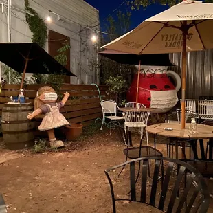 an outdoor patio area with tables and umbrellas