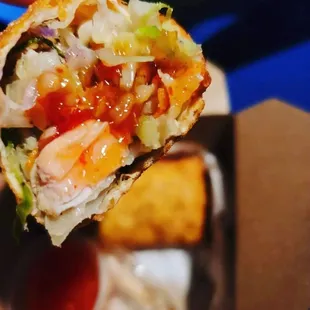 a hand holding a piece of food