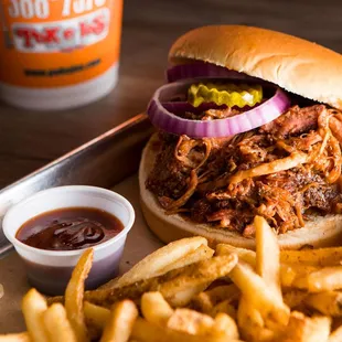 ows a pulled pork sandwich and fries