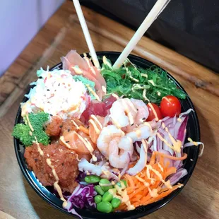 a bowl of food with chopsticks