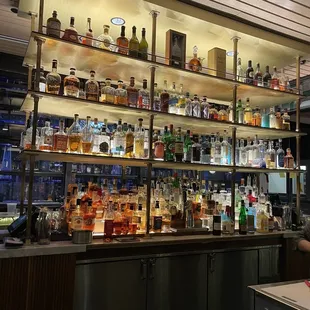 a bar with shelves full of liquor