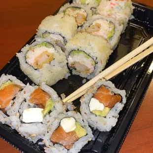 a plate of sushi and chopsticks