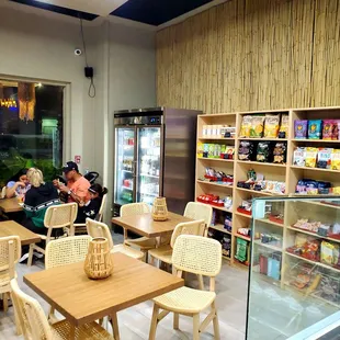 the inside of a restaurant with tables and chairs