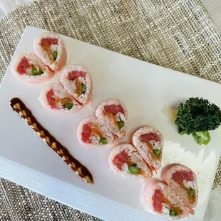 a plate of sushi and broccoli