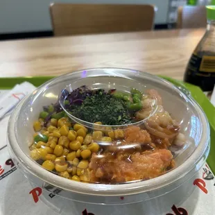 Spicy salmon, sushi rice, corn, cilantro, shrimp, edamame, poke sauce.