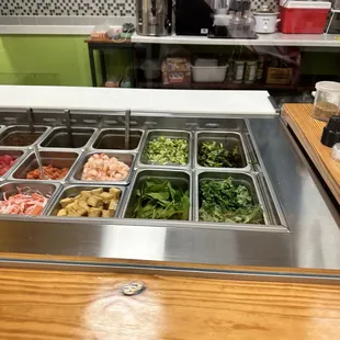 a variety of salads in a buffet