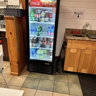 a soda cooler in a kitchen