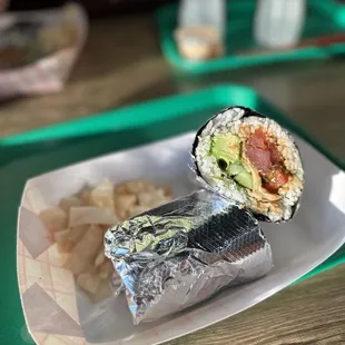 a burrito and chips on a tray