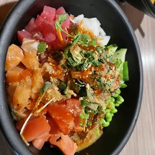 Poke Bowl with Spicy Tuna, Ahi Tuna, Salmon, brown Rice, Cilantro, Edemame, Cucumber, Pickled Onion. You build your own bowl.