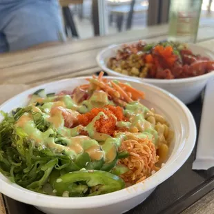 two bowls of food on a tray