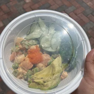 a person holding a bowl of food