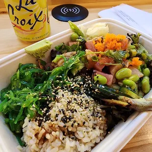 a container of rice, asparagus, and vegetables