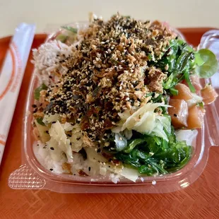 a plate of food with rice and greens