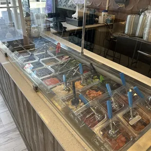 a variety of food in a display case