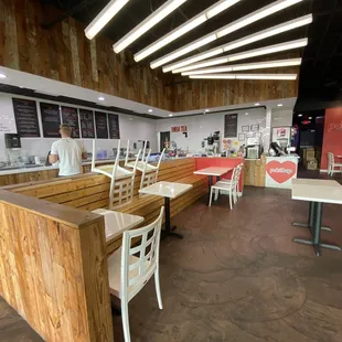 the inside of a restaurant with tables and chairs