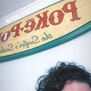 a man in front of a surfboard