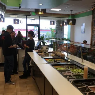 people standing in line at a buffet