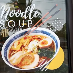 a bowl of noodles and chopsticks