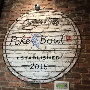 a sign on a brick wall