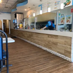 a man in a blue shirt behind the counter