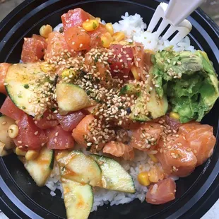Poke Bowl - Medium avocado! salmon! tuna! Corn! Cucumbers And white rice with spicey sauce furukake to top it off!