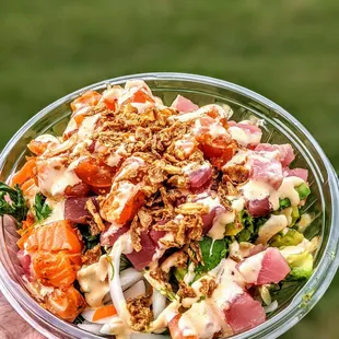 BYO salad bowl with ahi tuna, spicy salmon, toppings, and Sriracha aioli