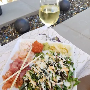 Salad with salmon, tuna, spicy tuna, shrimp. Cucumbers, cilantro, jalapeno, crab, nori and drizzled with spicy mayo and wasabi mayo.