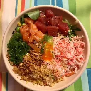 Poke bowl with salmon, tuna, crab, seaweed salad