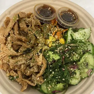 Tofu poke bowl, tofu is on left.  I selected seaweed salad was one of my sides, right, veg and brown rice.
