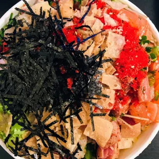 a bowl of sushi and vegetables