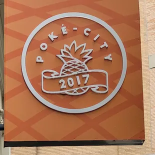 Poke-City sign with logo of a pineapple and a banner reading 2017