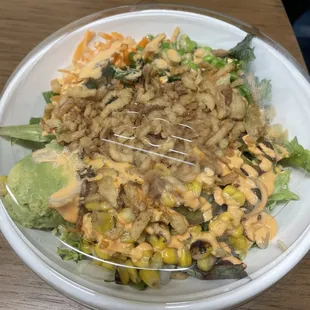 salmon bowl with brown rice cucumber, and fire roasted corn with tempura crunch