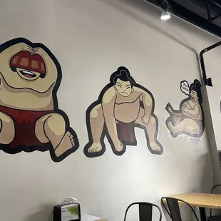 a wall painting of sumo wrestlers