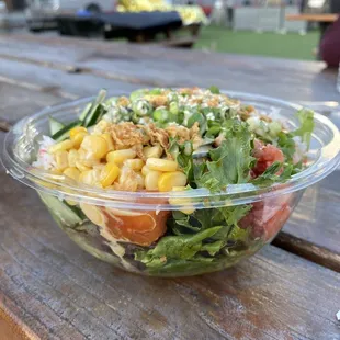a salad in a bowl on a picnic table