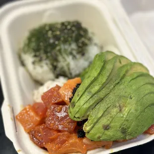 an avocado and rice dish in a styrofoam container