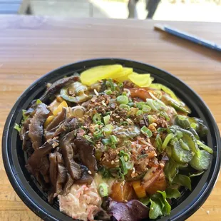 Medium bowl. Half brown rice/ have mixed greens with only salmon.