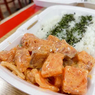 a plate of food with rice and meat